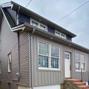 Vinyl Dutchlap Siding, Vinyl 10" Board & Batten in the color Greystone, Vinyl Dutchlap Siding in the color Carbon with Greystone Trim