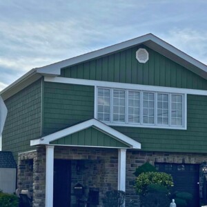 Vinyl Shake Siding in the color Olive, Board and Batten in the Gable in the color Olive with White Trim