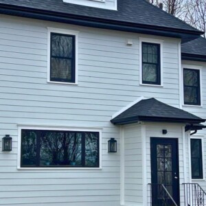 James Hardi Fiber Cement Siding in the color White with Black Soffits and PVC Window Trim