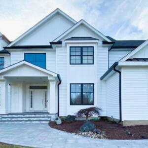 Vinyle Dutchlap Siding in the color White with Board & Batten look created with Azek on the Gables with Black Trim