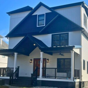 Vinyl Dutchlap Siding in the Color White, Vinyl Shake in the color Black, Board and Batten in the Color White with Black Trim