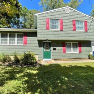 Vinyl Siding in Spruce color with Lighthouse Red shutters