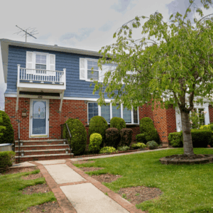 Brick Base with Blue Vinyl Siding and Black Shingles