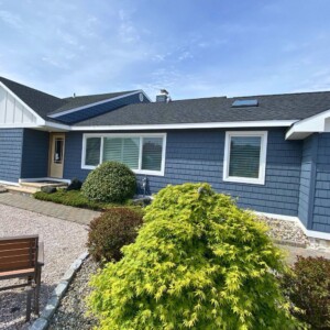 Vinyl Shake in the color Pacific Blue with White Board & Batten on the Gables