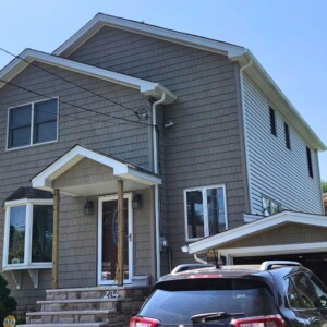 Vinyl Shake in the color Clay, Vinyl Dutchlap Siding in the color Bone with white trim