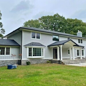 Vinyl Shake in the color Greystone with Vinyl Board and Batten in the color Greystone with White trim