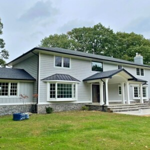 Vinyl Shake in the color Greystone with Vinyl Board and Batten in the color Greystone with White trim