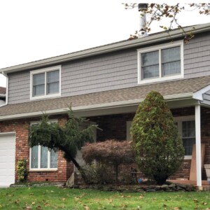 Vinyl Craneboard 7" fully insulated Siding and Vinyl Shake in the color Charcoal with White trim